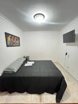 a bedroom with a large black bed in a room at exclusivo apartamento laureles in Medellín