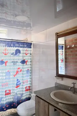a bathroom with a toilet and a sink and a mirror at Pájaros y Mariposas Casa Campestre in La Rochela