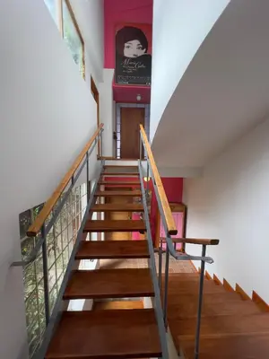 a staircase in a house with wooden floors and a painting at Son de la Loma Apartments in Envigado