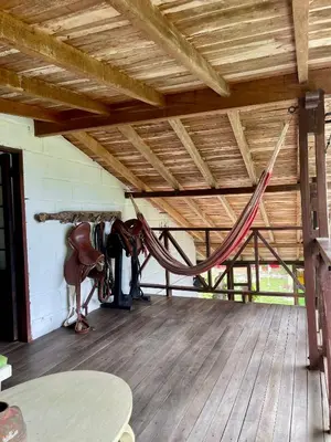 a room with a horse and a hammock in a building at Hermosa casa finca en Marinilla in Marinilla