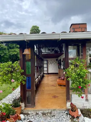 an outside view of a house with a porch at Hermosa casa finca en Marinilla in Marinilla