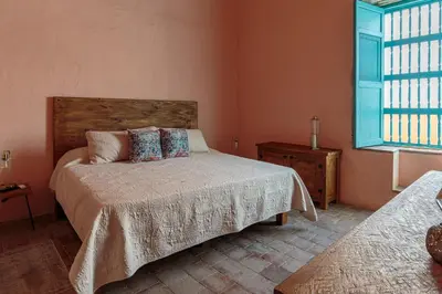 a bedroom with a bed and a window at Casa la batuta in Santa Fe de Antioquia