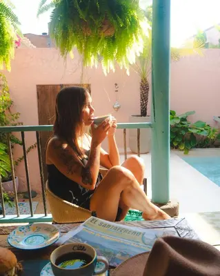 a woman sitting in a chair holding a cell phone at Casa la batuta in Santa Fe de Antioquia