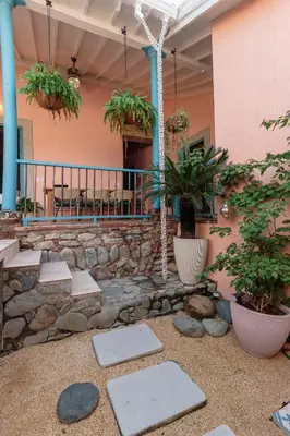 a patio with rocks and plants in front of a building at Casa la batuta in Santa Fe de Antioquia
