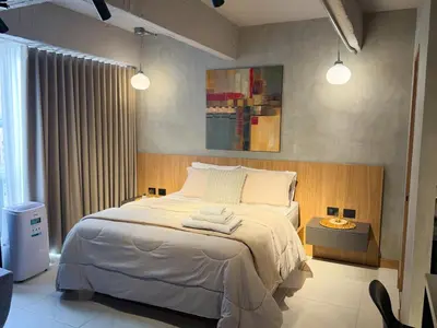 a bedroom with a bed with two towels on it at Reposso Studio Poblado in Medellín