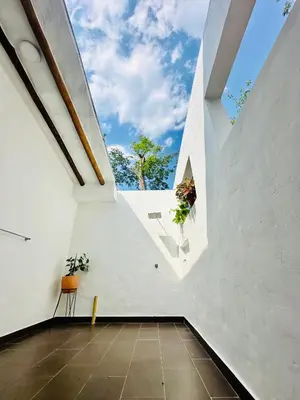 a room with white walls and a large window at Villa Paulina in Honda