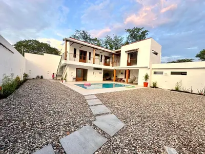 a house with a swimming pool in the yard at Villa Paulina in Honda