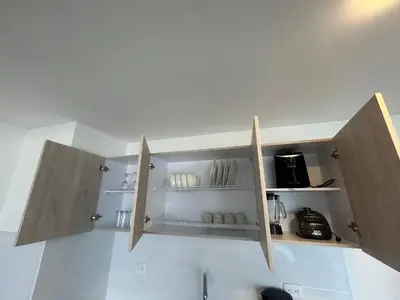 a kitchen with wooden cupboards on the wall at Amplio y Suntuoso - estrato 6 in Manizales