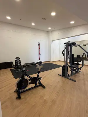 a gym with several treadmills and weights in a room at Amplio y Suntuoso - estrato 6 in Manizales