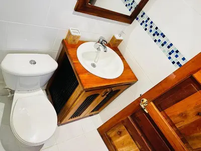 a bathroom with a white toilet and a sink at My Paradise Tamesis in Támesis