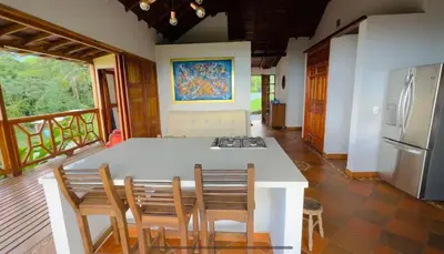 a kitchen with a table with chairs and a refrigerator at My Paradise Tamesis in Támesis