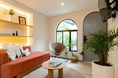 a living room with an orange couch and a table at Casa Fiora Laureles in Medellín