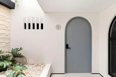 a room with white walls and an open door at Casa Fiora Laureles in Medellín