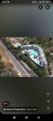 a television screen with a picture of a building and a road at Paraíso del sol in San Jerónimo