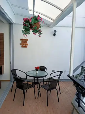 a table and chairs in a room with a plant at Paraíso del sol in San Jerónimo