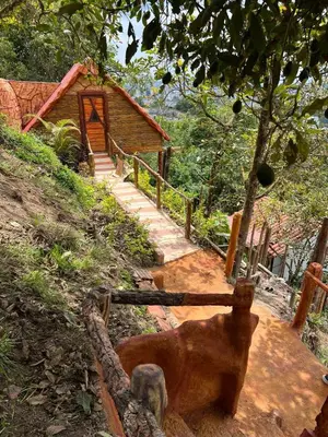 a statue of a dog in front of a house at Hotel Golden Hills Manizales in Manizales