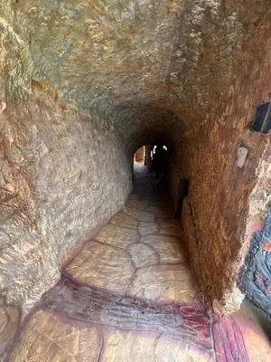 a tunnel in a cave with a stone wall at Hotel Golden Hills Manizales in Manizales