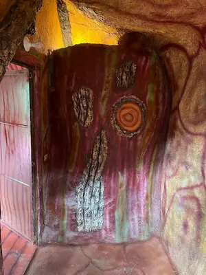 a painting of a face on the side of a wall at Hotel Golden Hills Manizales in Manizales