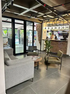 a living room with a couch and chairs and a table at Hotel Living 35 Suites Piso 8 Vip in Medellín