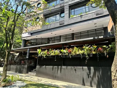 a building with potted plants on a balcony at Hotel Living 35 Suites Piso 8 Vip in Medellín