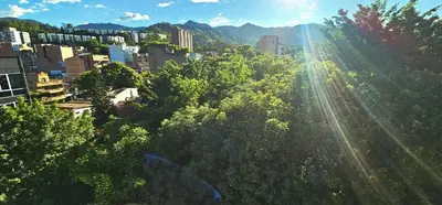 a view of a city with trees and buildings at Hotel Living 35 Suites Piso 8 Vip in Medellín