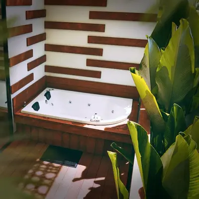 a bath tub in a room with plants at Dharma Hotel Boutique Spa in San Jerónimo