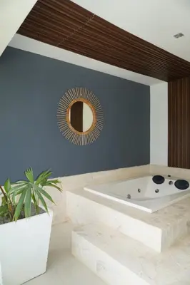 a bathroom with a bath tub and a mirror at Dharma Hotel Boutique Spa in San Jerónimo