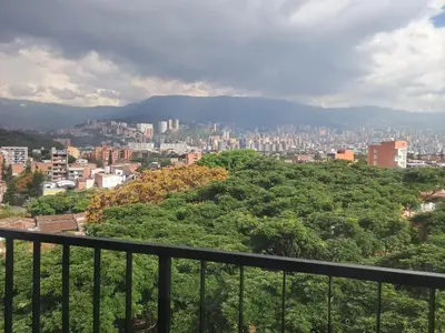 a view of a city from a balcony at Hotel ECO 44 in Medellín