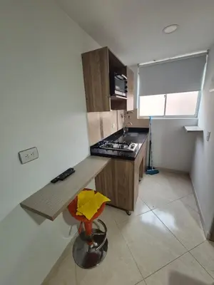 a kitchen with a counter and a stove top oven at ApartaLoft 12, NevadaLofts Sabaneta in Sabaneta