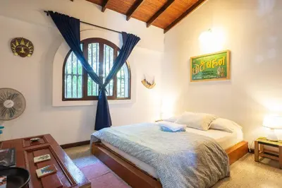a bedroom with a bed and a window at Colonial Villa in Laureles, Unique&Special House in Medellín