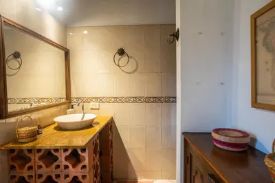 a bathroom with a sink and a mirror at Colonial Villa in Laureles, Unique&Special House in Medellín