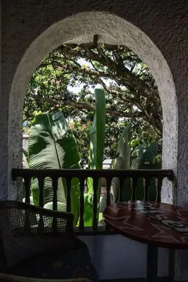 an archway with a table and a table and some plants at Colonial Villa in Laureles, Unique&Special House in Medellín