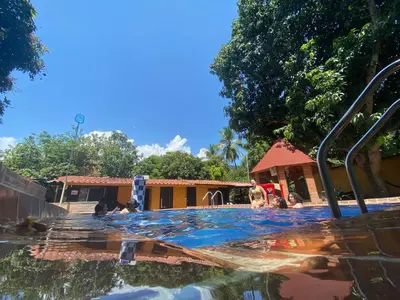 a group of people in a swimming pool at Finca Santa fe de Antioquia in Sopetran