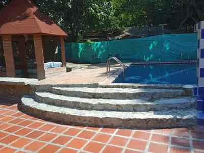 a set of stairs next to a swimming pool at Finca Santa fe de Antioquia in Sopetran