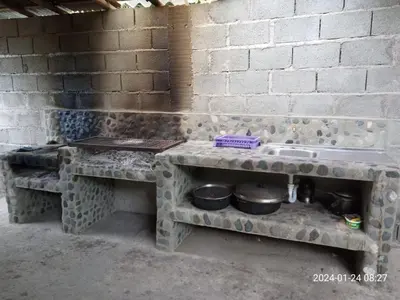 a kitchen with a stone counter with pots and pans at Finca Santa fe de Antioquia in Sopetran