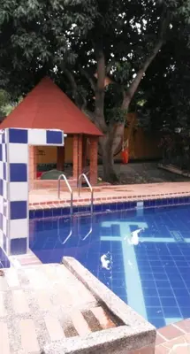 a swimming pool with a gazebo next to a house at Finca Santa fe de Antioquia in Sopetran