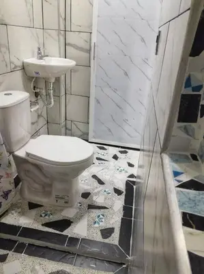a bathroom with a toilet and a sink at Parcela - Casa del árbol in Doradal