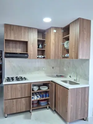 a kitchen with wooden cabinets and a sink at Acogedor Apartamento de 3 dormitorios con baños privados - Guatapé Antioquia in Guatapé