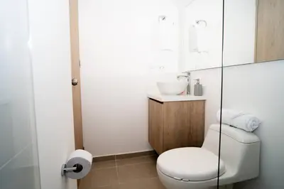 a bathroom with a white toilet and a sink at Amazing cozy & new flat 3 bedrooms in Medellin best location in Medellín