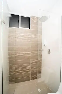 a bathroom with a shower with a glass door at Amazing cozy & new flat 3 bedrooms in Medellin best location in Medellín