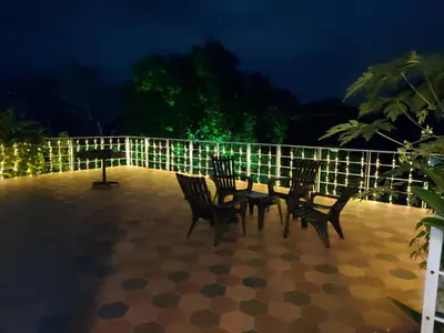 two chairs and a table on a patio at night at Finca Ecológica Sopetran in Sopetran