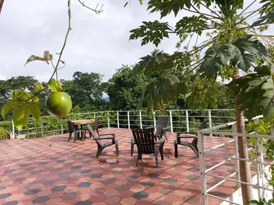 a group of chairs sitting on a patio at Finca Ecológica Sopetran in Sopetran