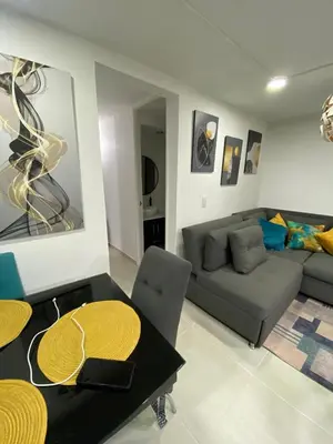 a living room with a couch and a table at Apartamento Resort Rionegro in Rionegro