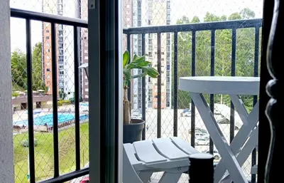 a balcony with a table and a view of a building at Apartamento Resort Rionegro in Rionegro