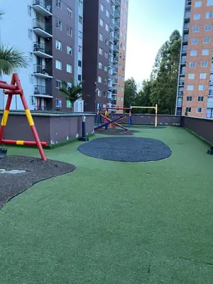 a playground with green grass and swings at Apartamento Resort Rionegro in Rionegro