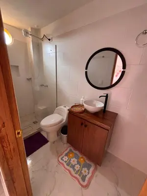 a bathroom with a toilet and a sink and a mirror at 1Cálido y Amarillo in Jericó