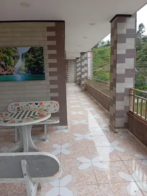 a patio with two benches and a painting on a wall at Hotel Hollywood Paradise ZF in Rionegro