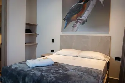 a bedroom with a bed with a bird painting on the wall at Hotel Yuma in La Dorada