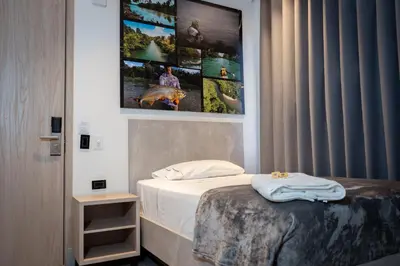 a bedroom with a bed and a picture on the wall at Hotel Yuma in La Dorada