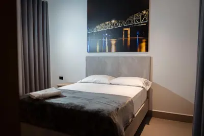 a bedroom with a bed with a picture on the wall at Hotel Yuma in La Dorada